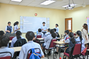 Student confidently presenting a project to classmates, showcasing communication and leadership skills